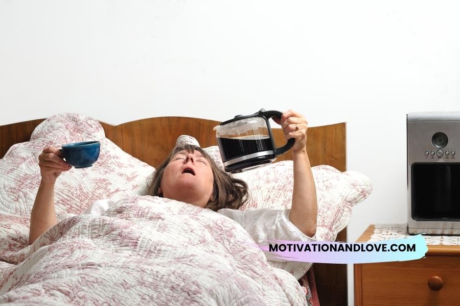Woman lying in bed with open mouth, holding a blue cup in one hand and a full coffee carafe in the other; coffee maker visible on bedside table.