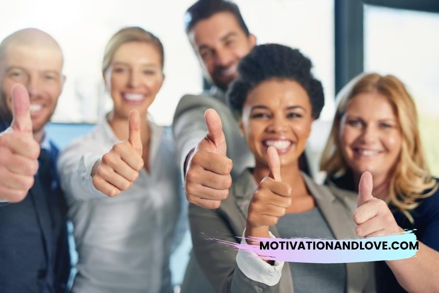 Five diverse adults in business attire smile and give thumbs-up gestures.